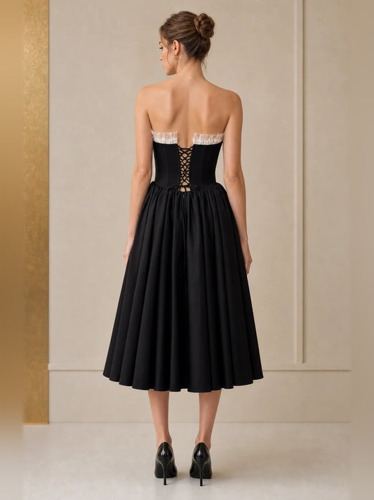Black tea-length homecoming dress, back view showing the rear of the dress