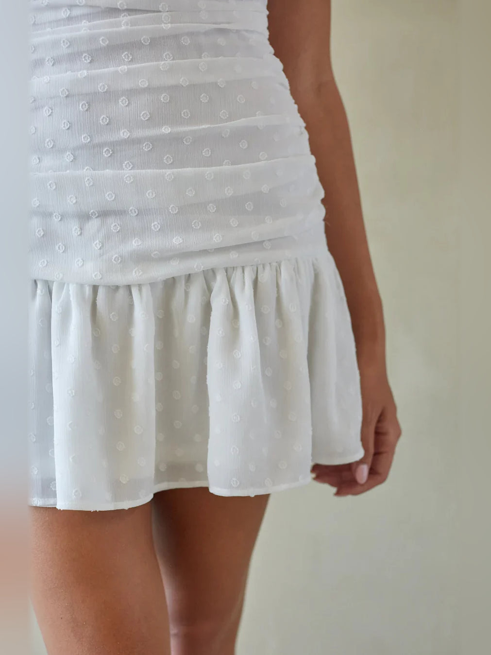 White mini homecoming dress, alternate view showing the skirt and hem