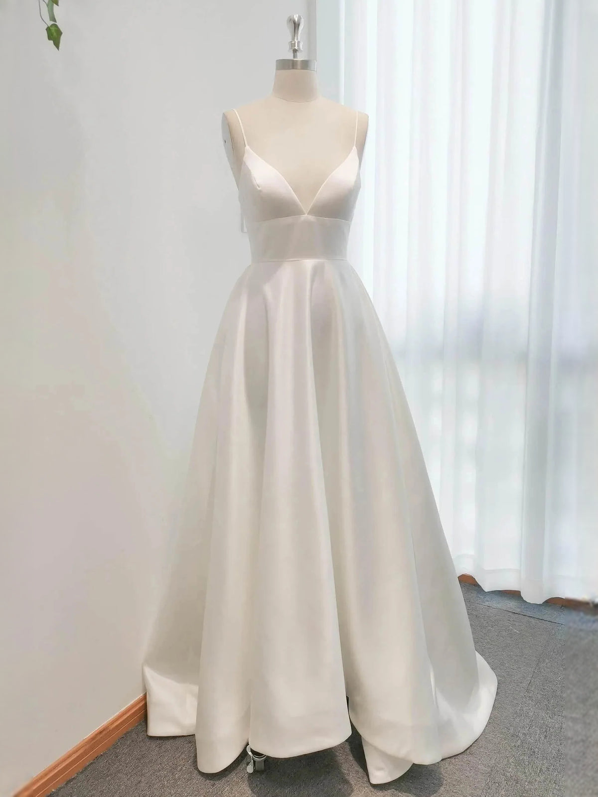 Ivory floor-length wedding dress, alternate view showing the skirt and hem