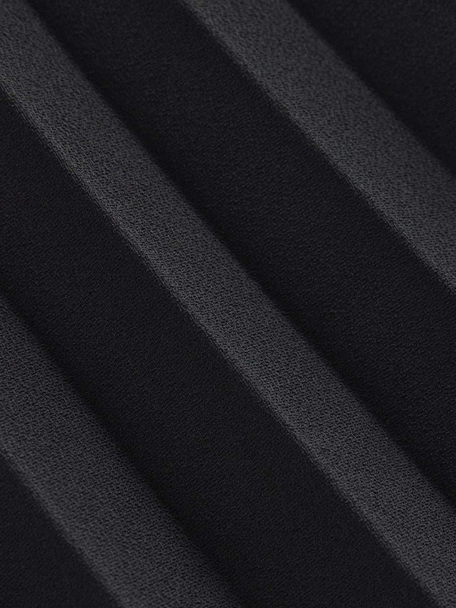 Black mini homecoming dress, alternate view showing the skirt and hem