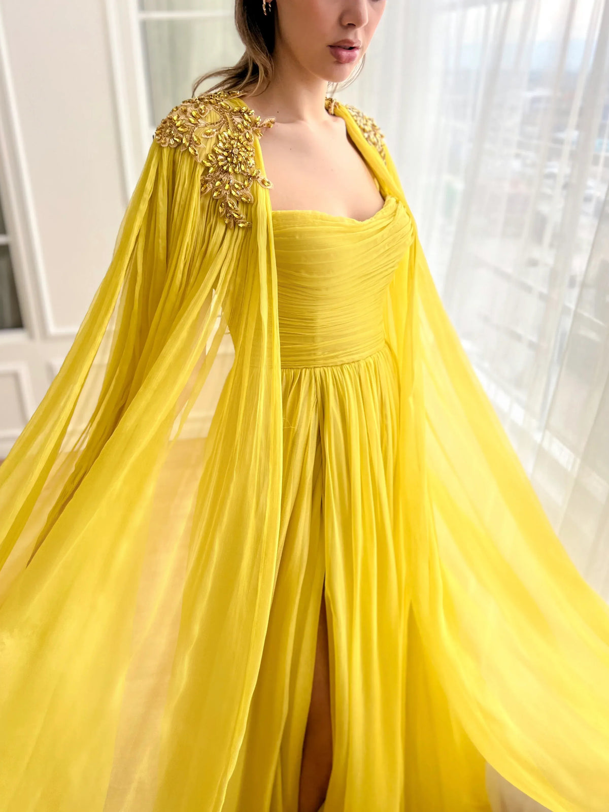 Yellow a-line floor-length formal dress with skirt slit, alternate view showing the hem