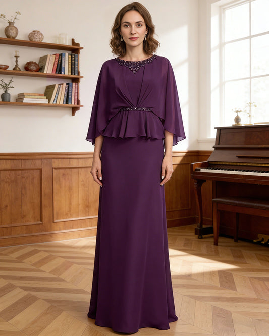 long capelet mother of the bride dress with beaded neckline, peplum overlay, and floor length chiffon skirt shown in formal wedding guest styling