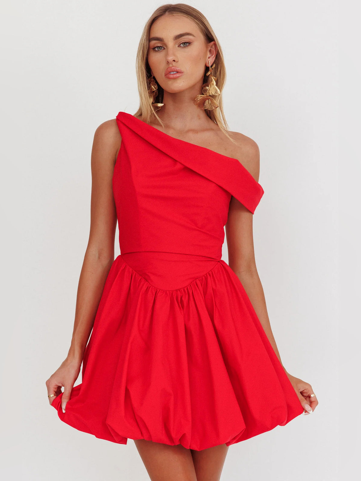 Red mini homecoming dress, front view showing the asymmetrical silhouette