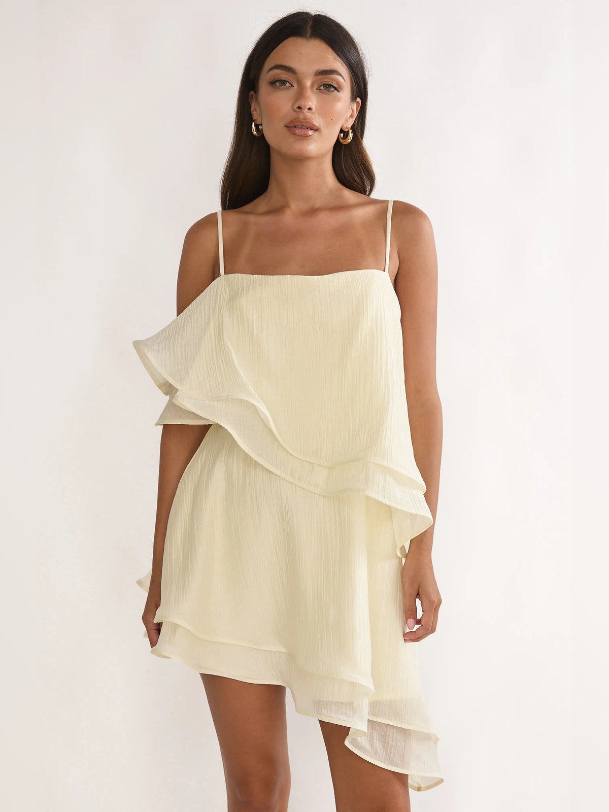 Cream mini homecoming dress, front view showing the asymmetrical silhouette