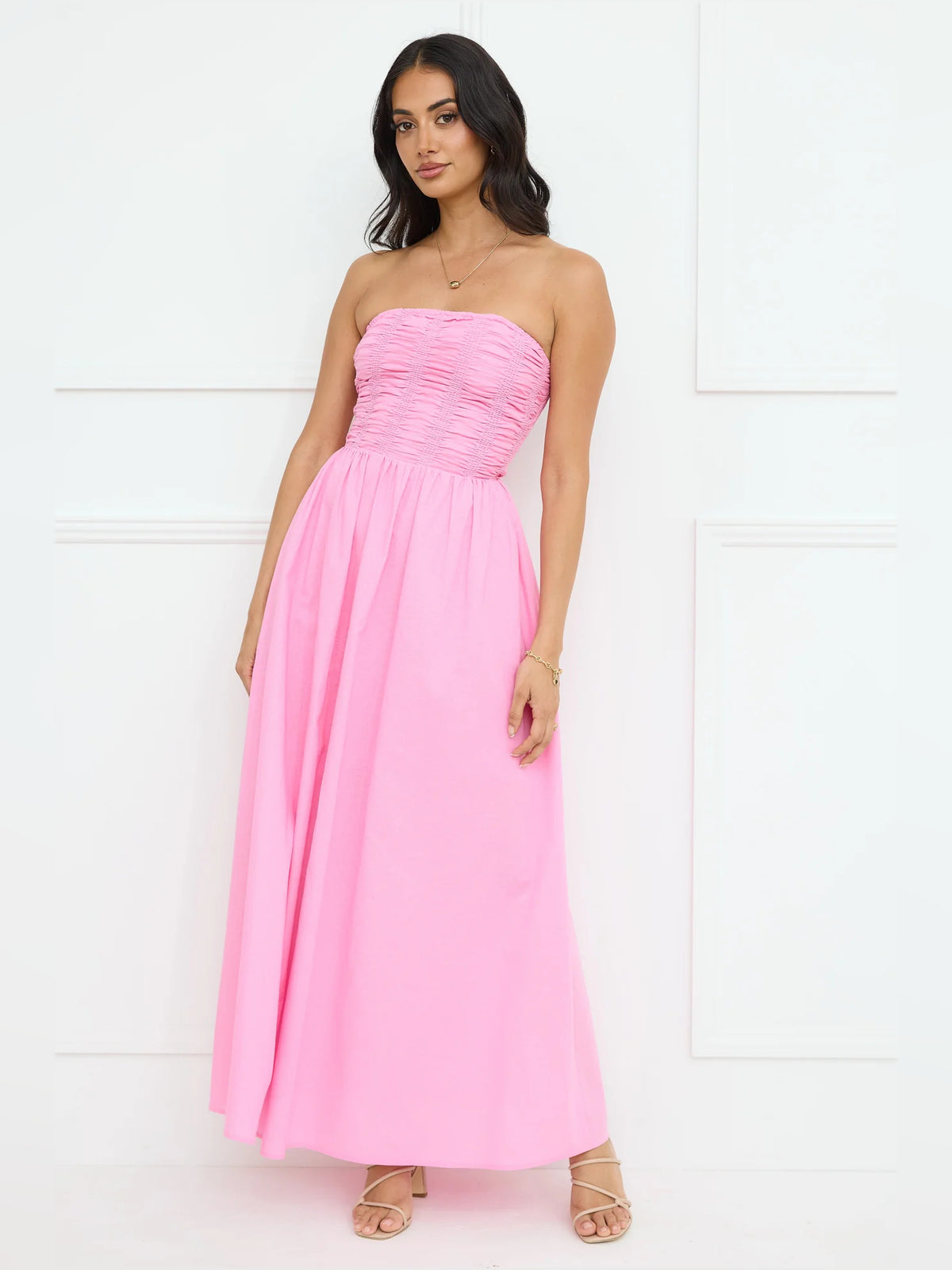 Pink a-line maxi formal dress with strapless neckline, full-length front view