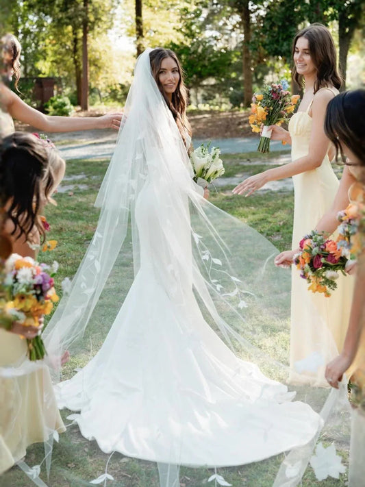 White floor-length wedding dress, front view showing the mermaid silhouette