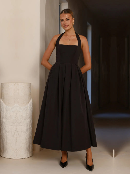 Black a-line maxi formal dress with halter neckline, full-length front view