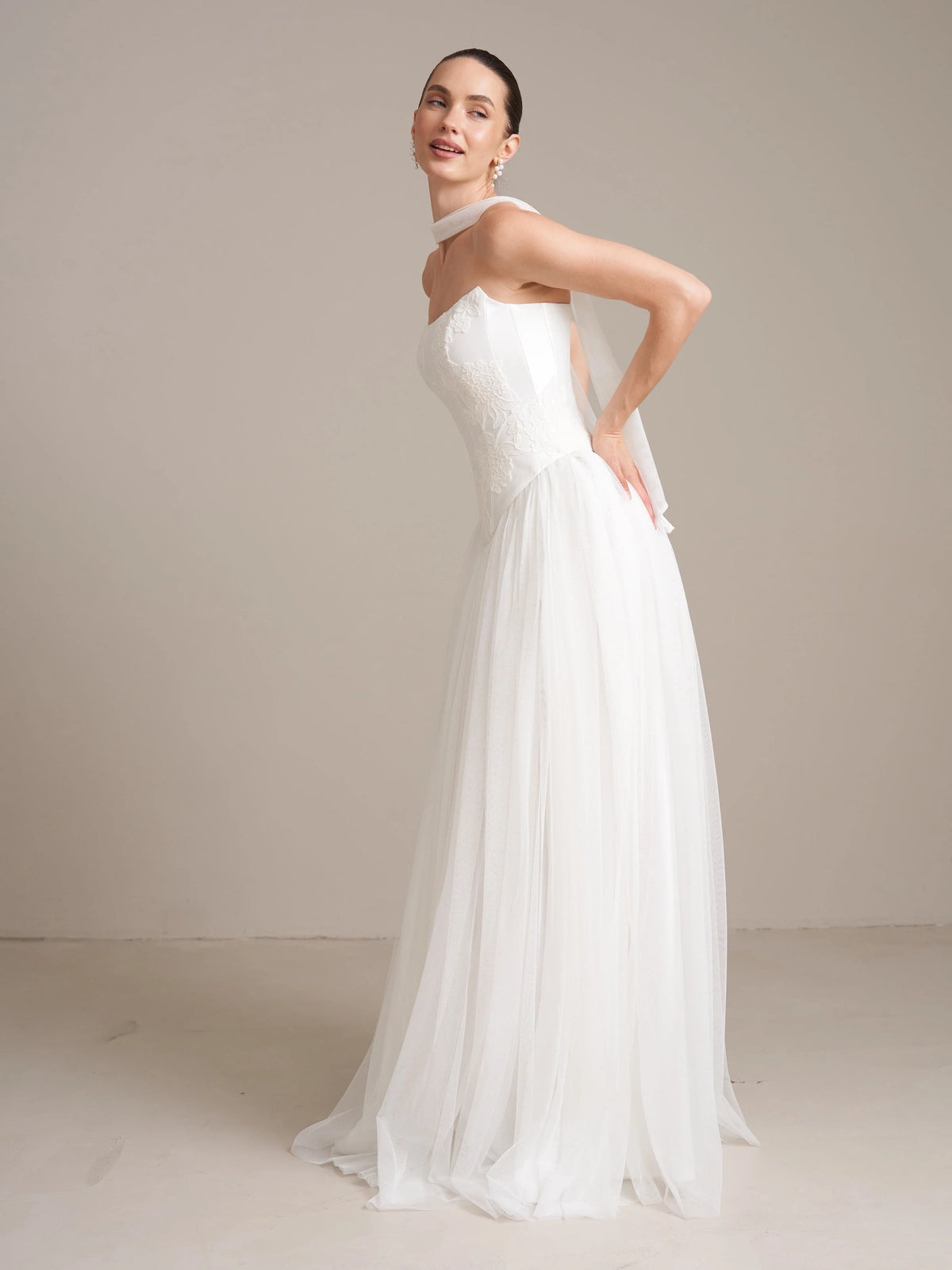 Ivory floor-length wedding dress, front view showing the a-line silhouette