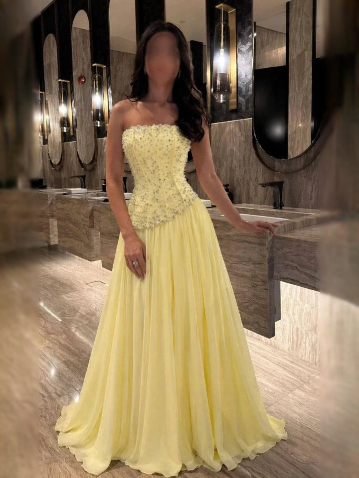 Pale Yellow a-line floor-length formal dress with strapless neckline, full-length front view
