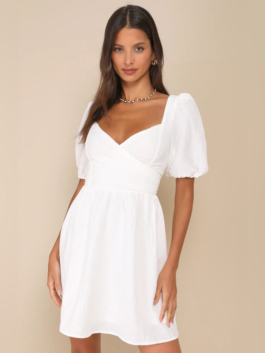 White mini homecoming dress, front view showing the wrap silhouette
