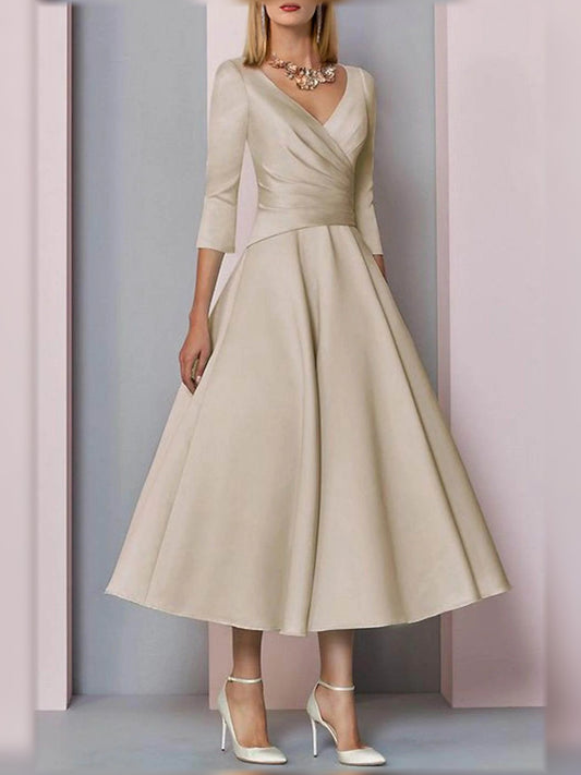 Champagne midi mother of the bride dress, front view showing the a-line silhouette