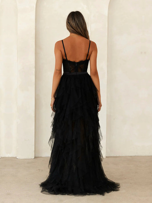 Black a-line maxi formal dress with ruffle details, full-length back view