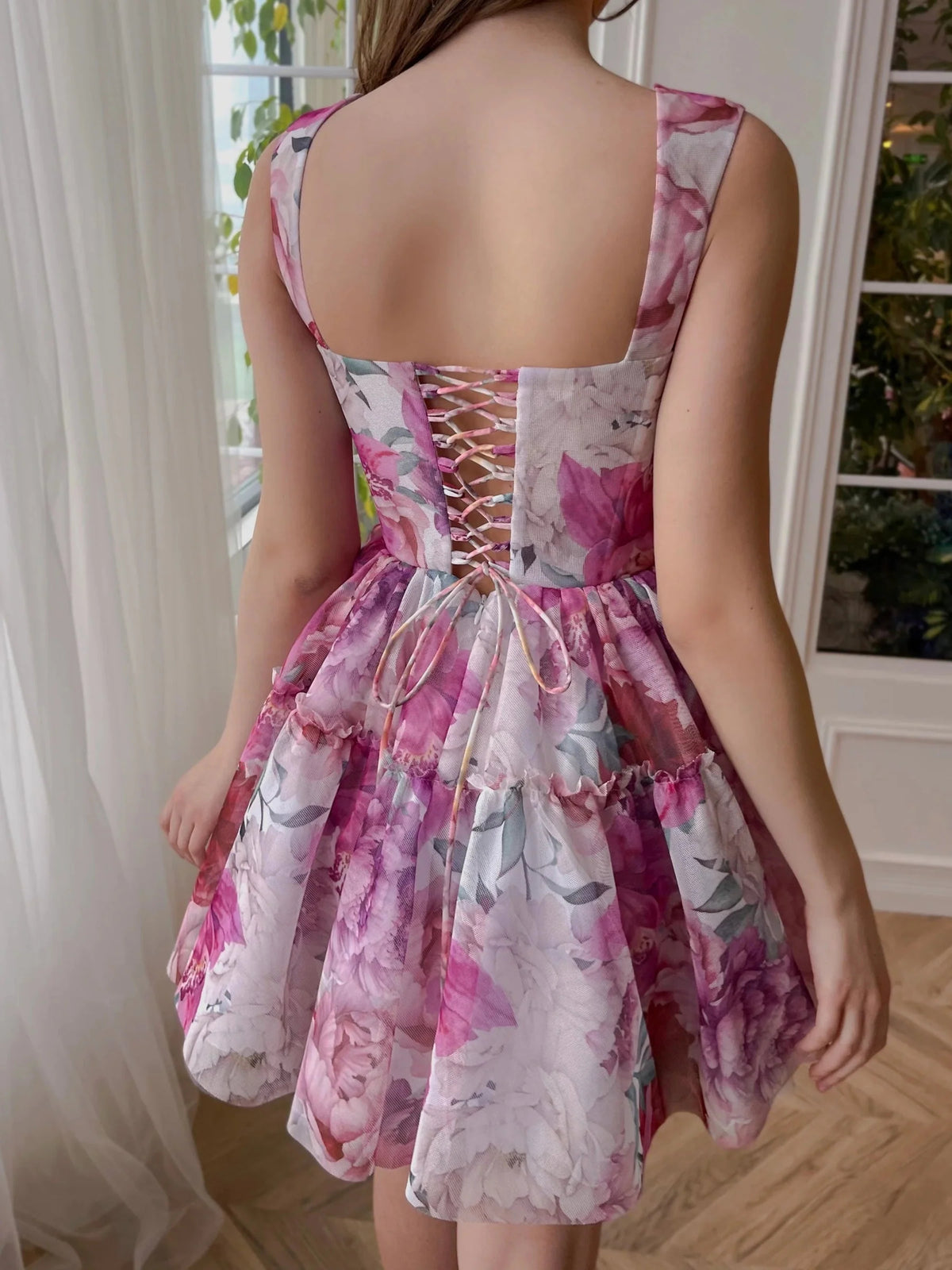Floral mini homecoming dress, back view showing the rear of the dress