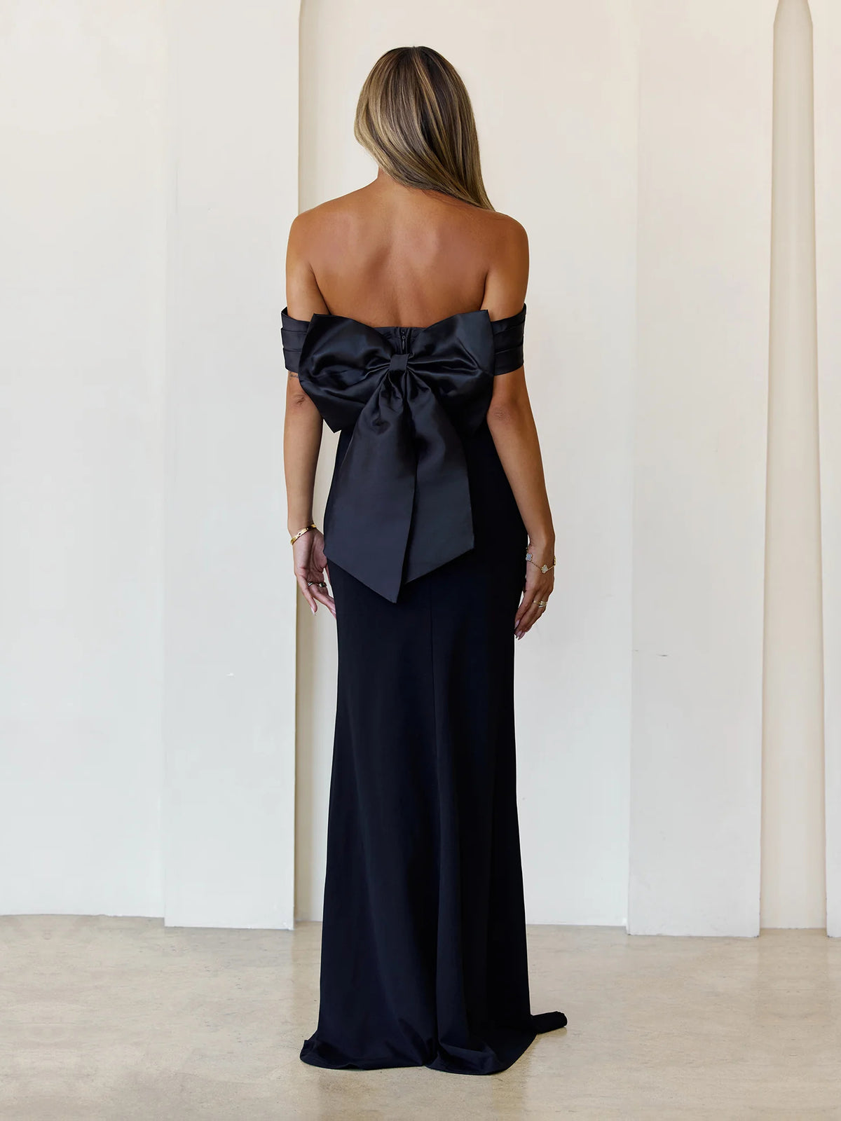 Black sheath maxi formal dress with bow detail, full-length back view