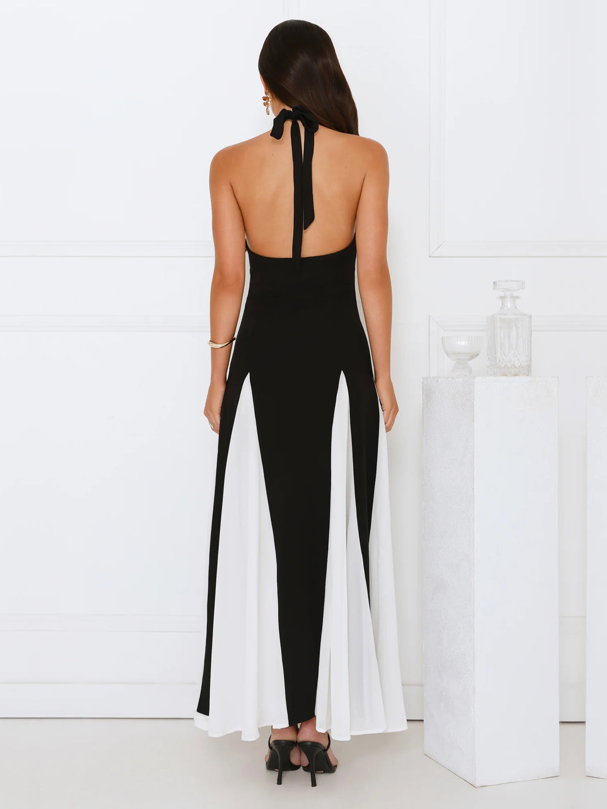 Black sheath maxi formal dress with cutout detail, full-length back view
