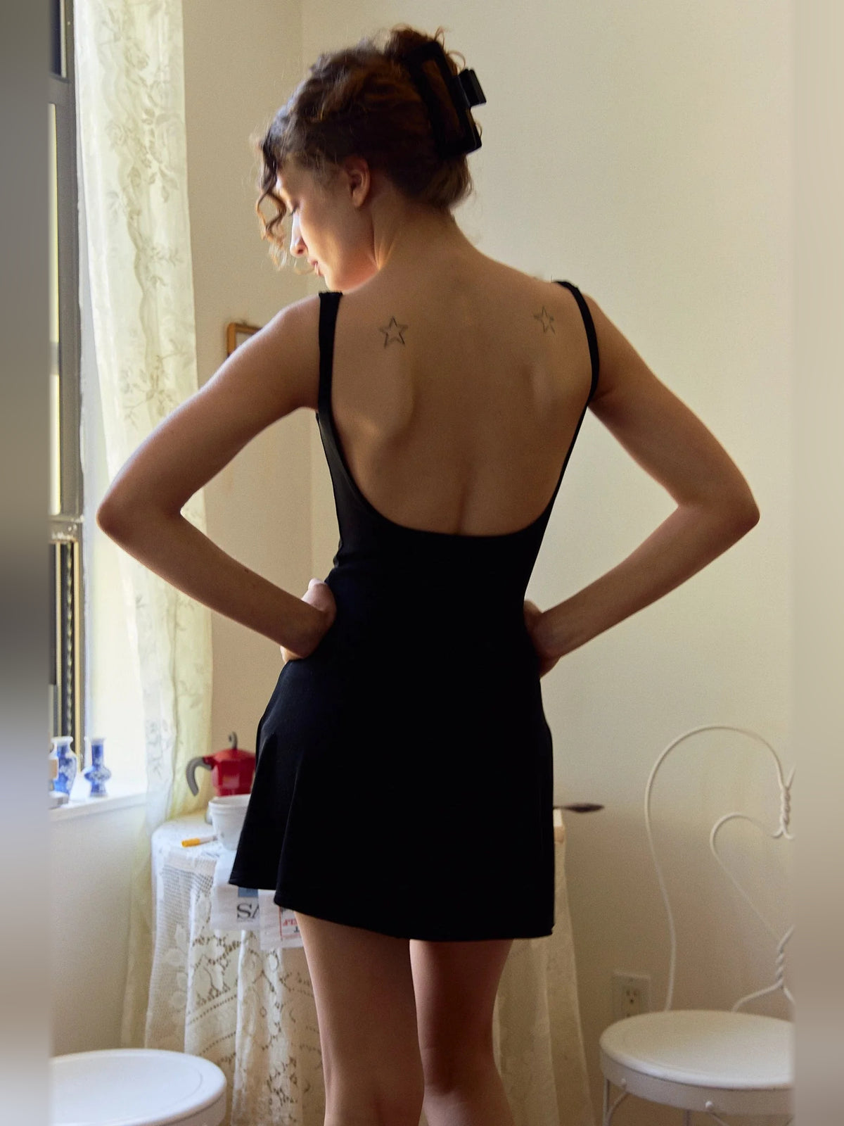 Black mini homecoming dress, back view showing the rear of the dress