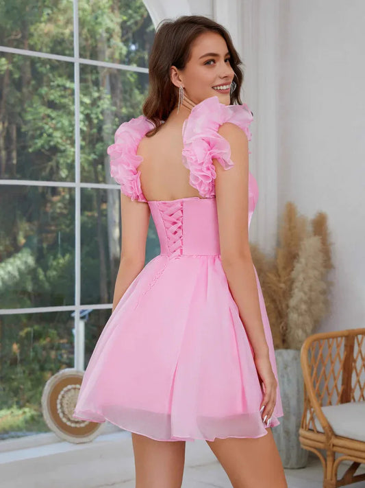 Light Pink mini homecoming dress, back view showing the rear of the dress