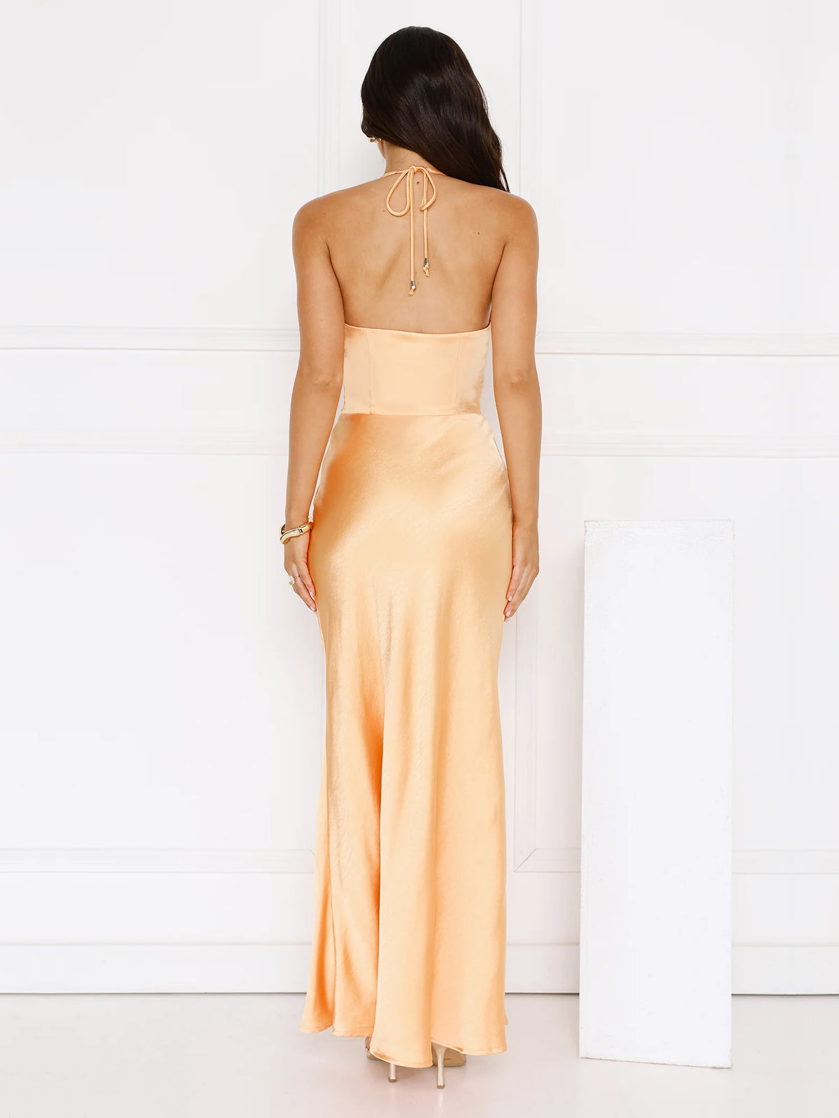Orange sheath maxi formal dress with skirt slit, full-length back view
