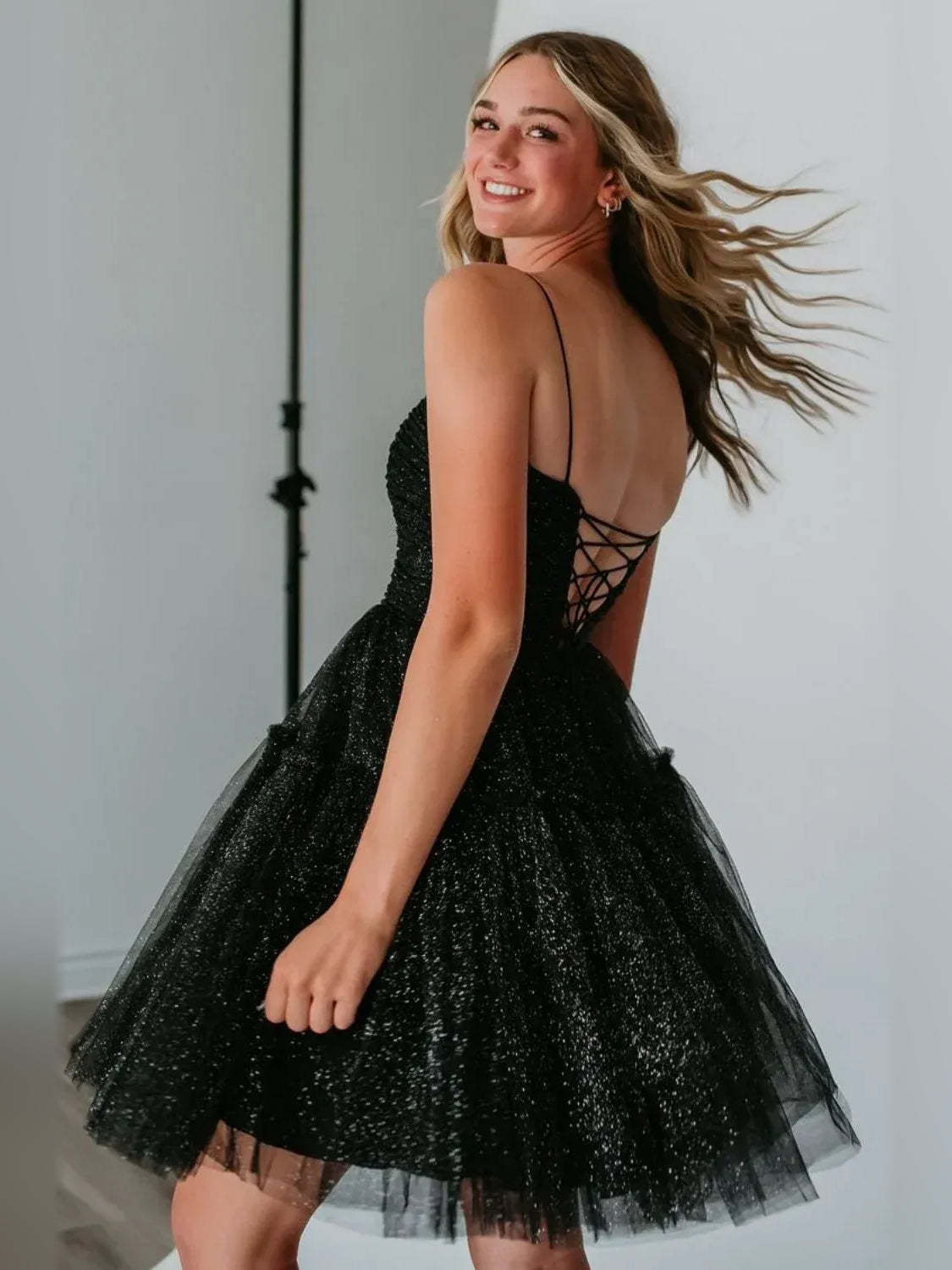 Black mini homecoming dress, back view showing the rear of the dress
