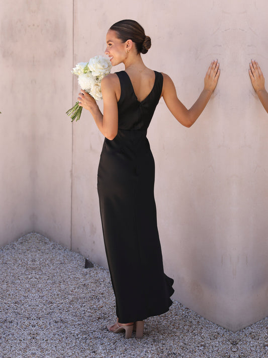 Black sheath maxi formal dress with skirt slit, full-length back view