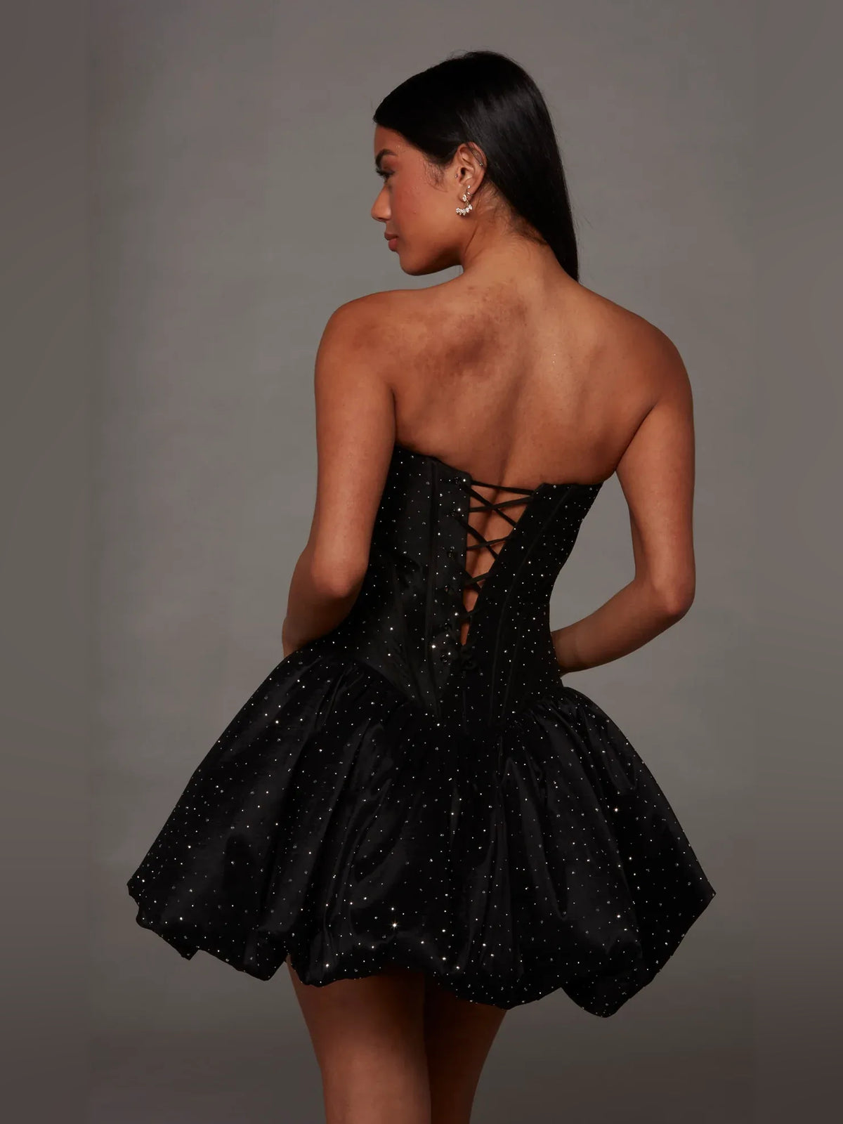 Black mini homecoming dress, alternate view showing the dress shape and hem