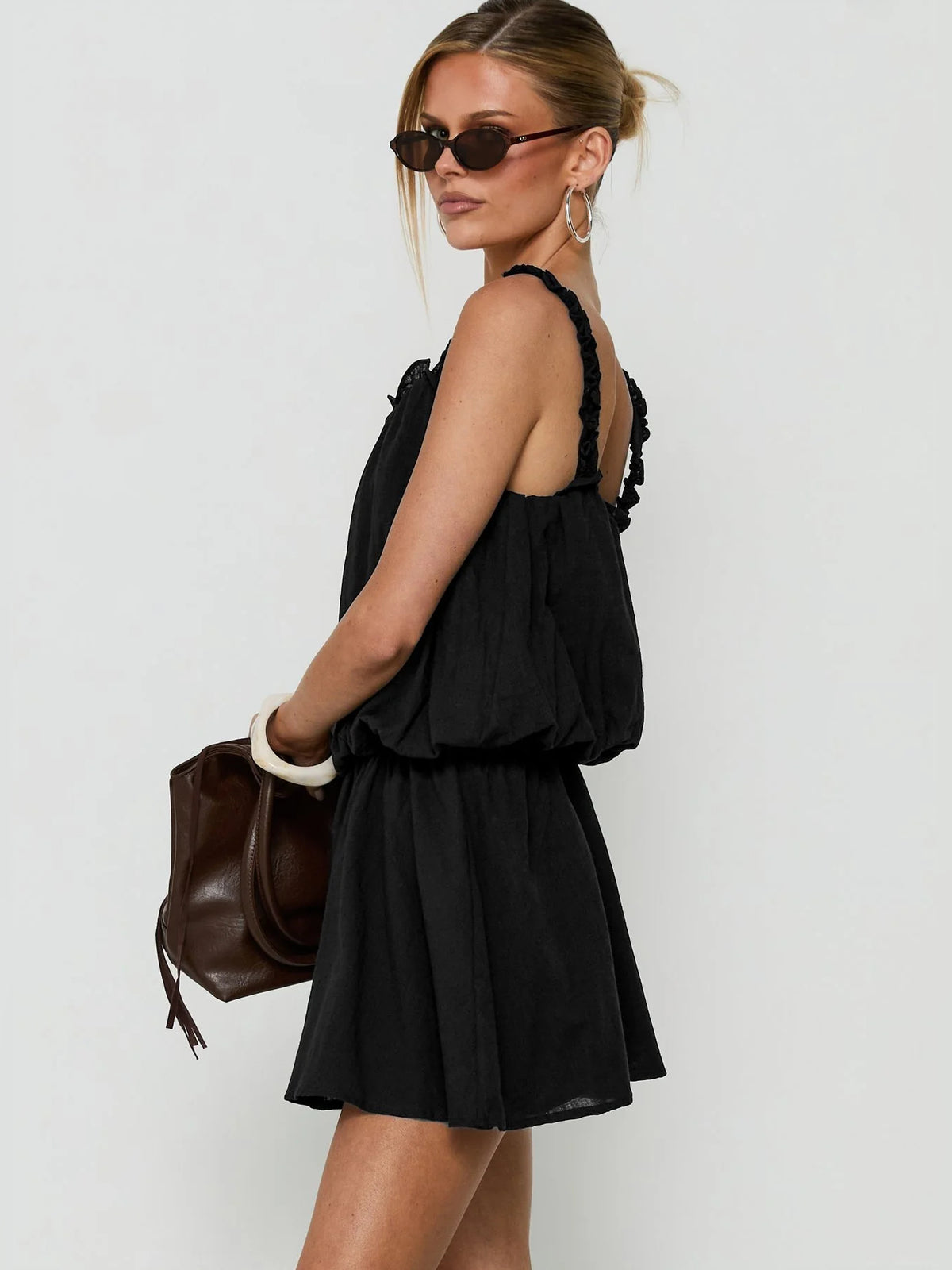 Black mini homecoming dress, alternate view showing the dress shape and hem