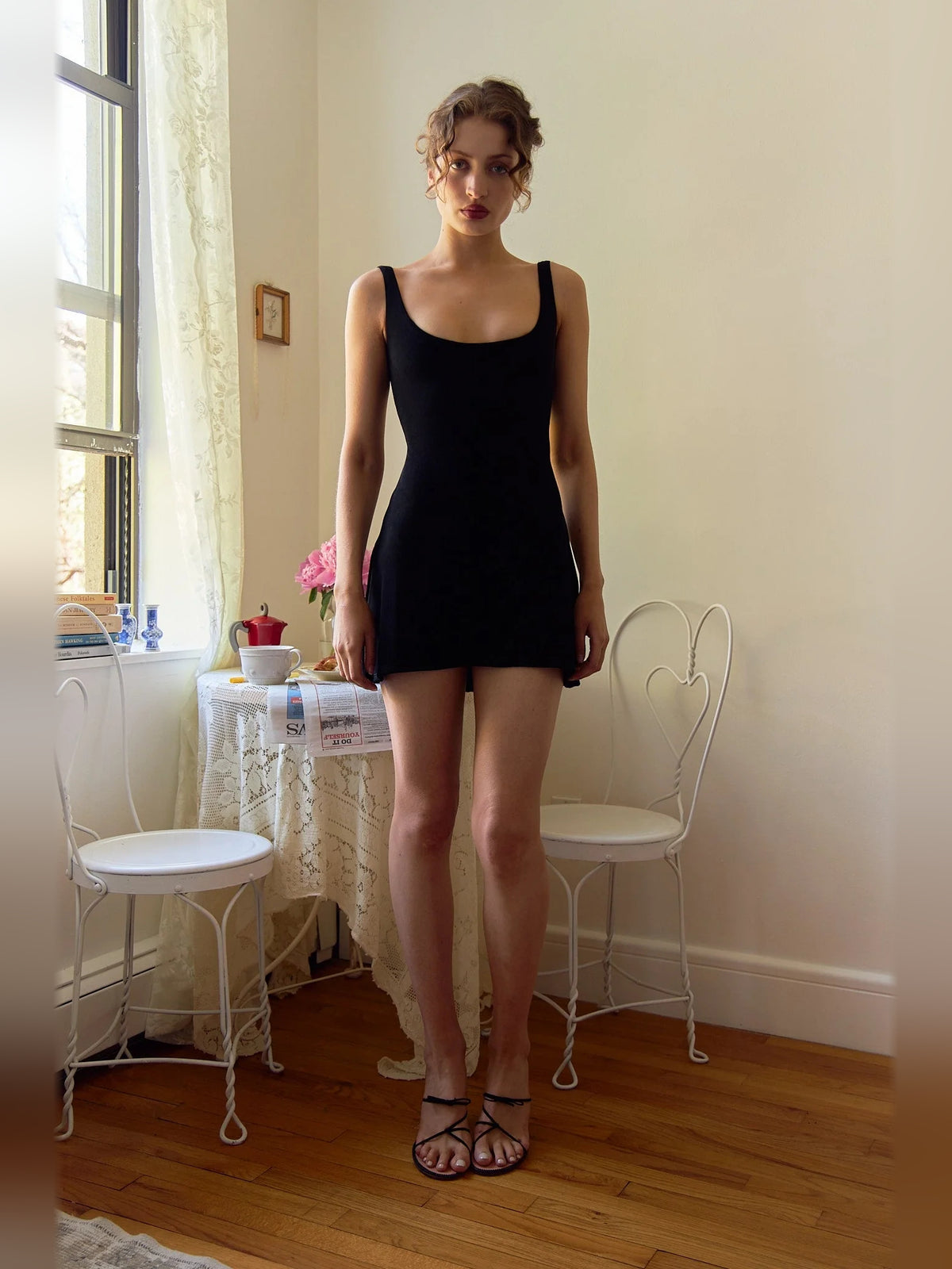 Black mini homecoming dress, alternate view showing the dress shape and hem