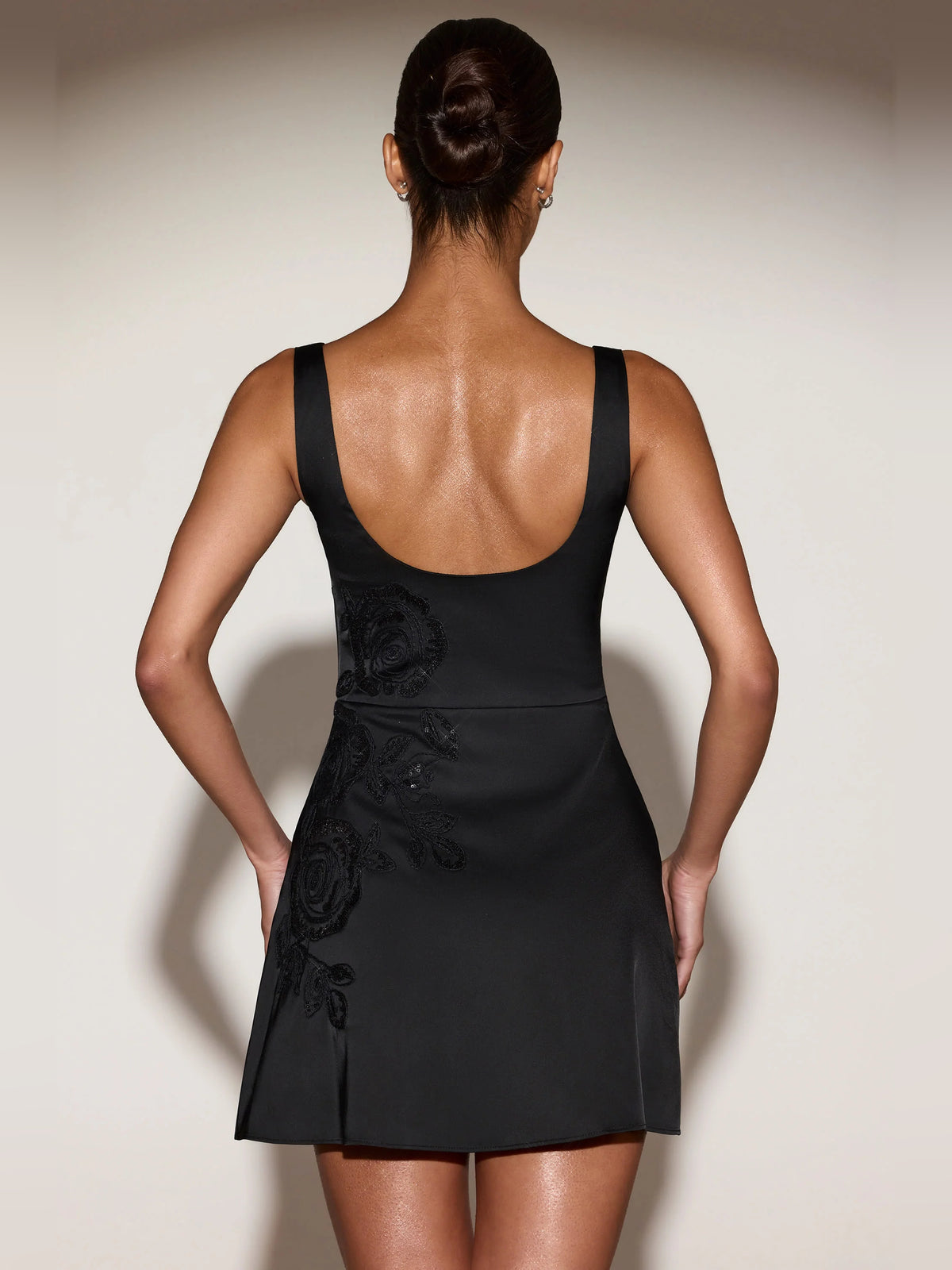 Black mini homecoming dress, alternate view showing the dress shape and hem