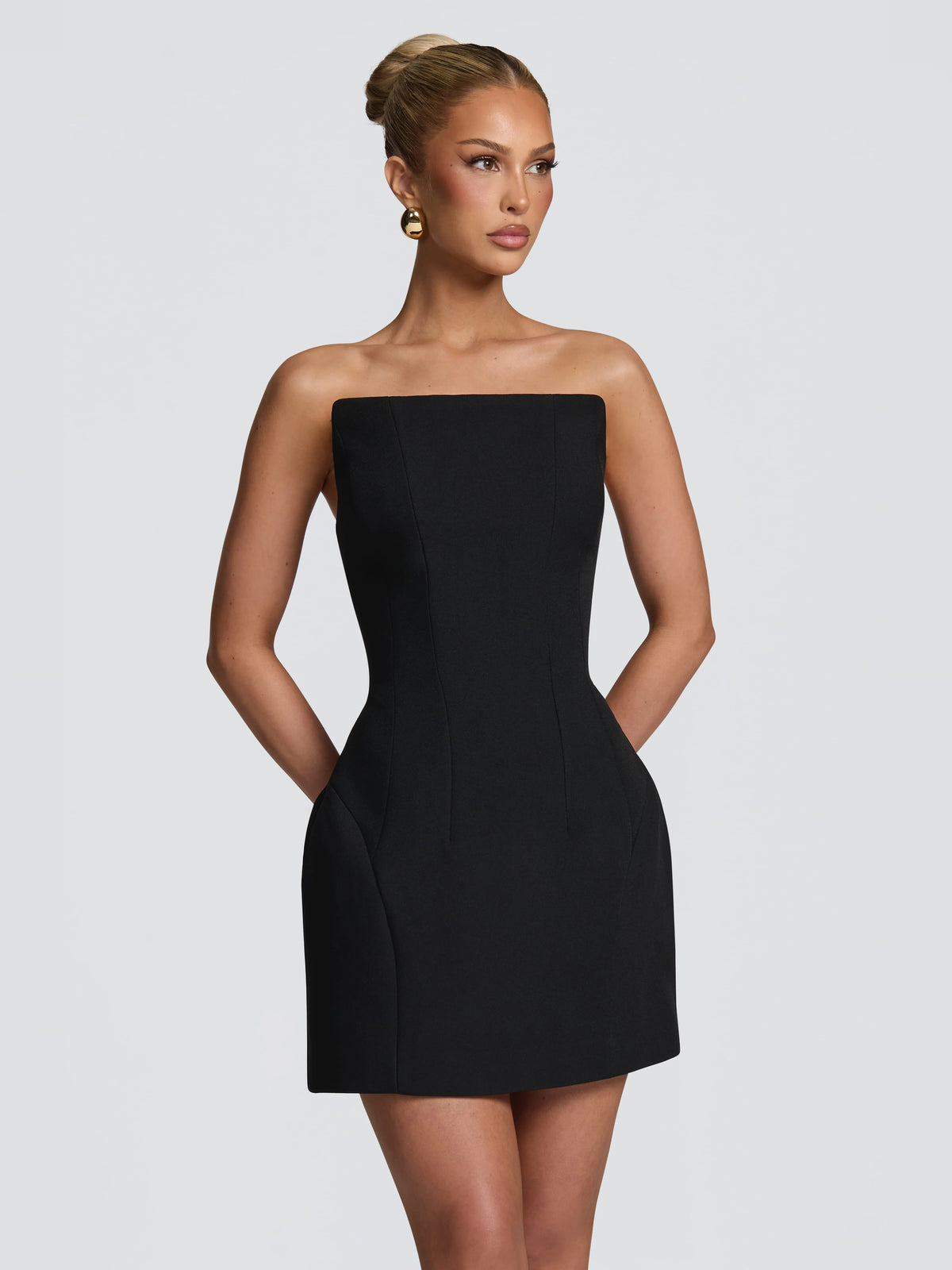 Black mini homecoming dress, alternate view showing the dress shape and hem