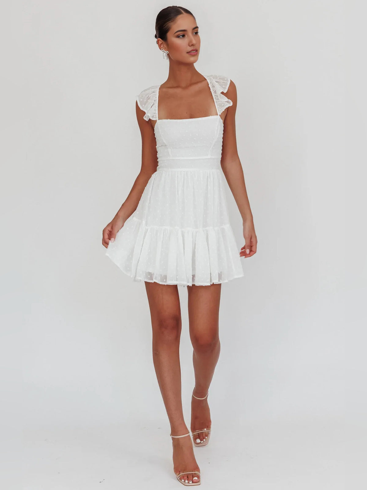 White mini homecoming dress, alternate view showing the dress shape and hem