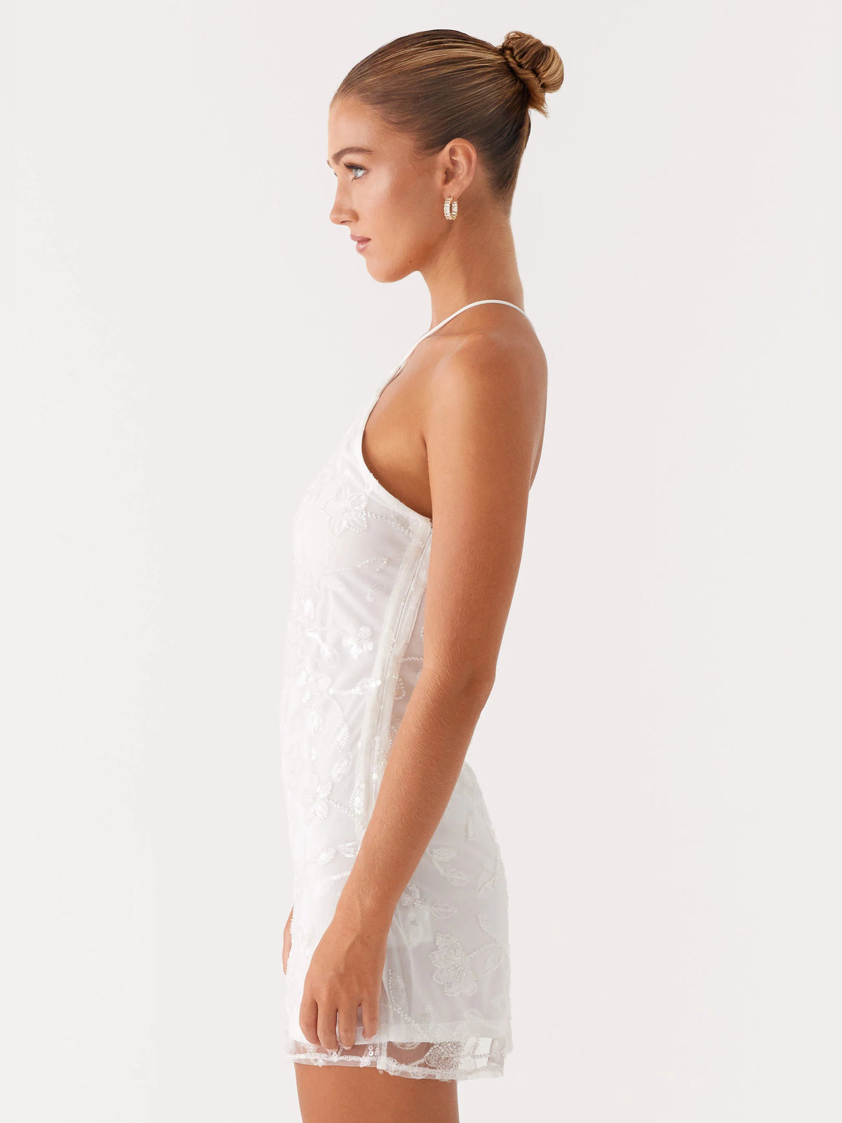 White mini homecoming dress, alternate view showing the dress shape and hem