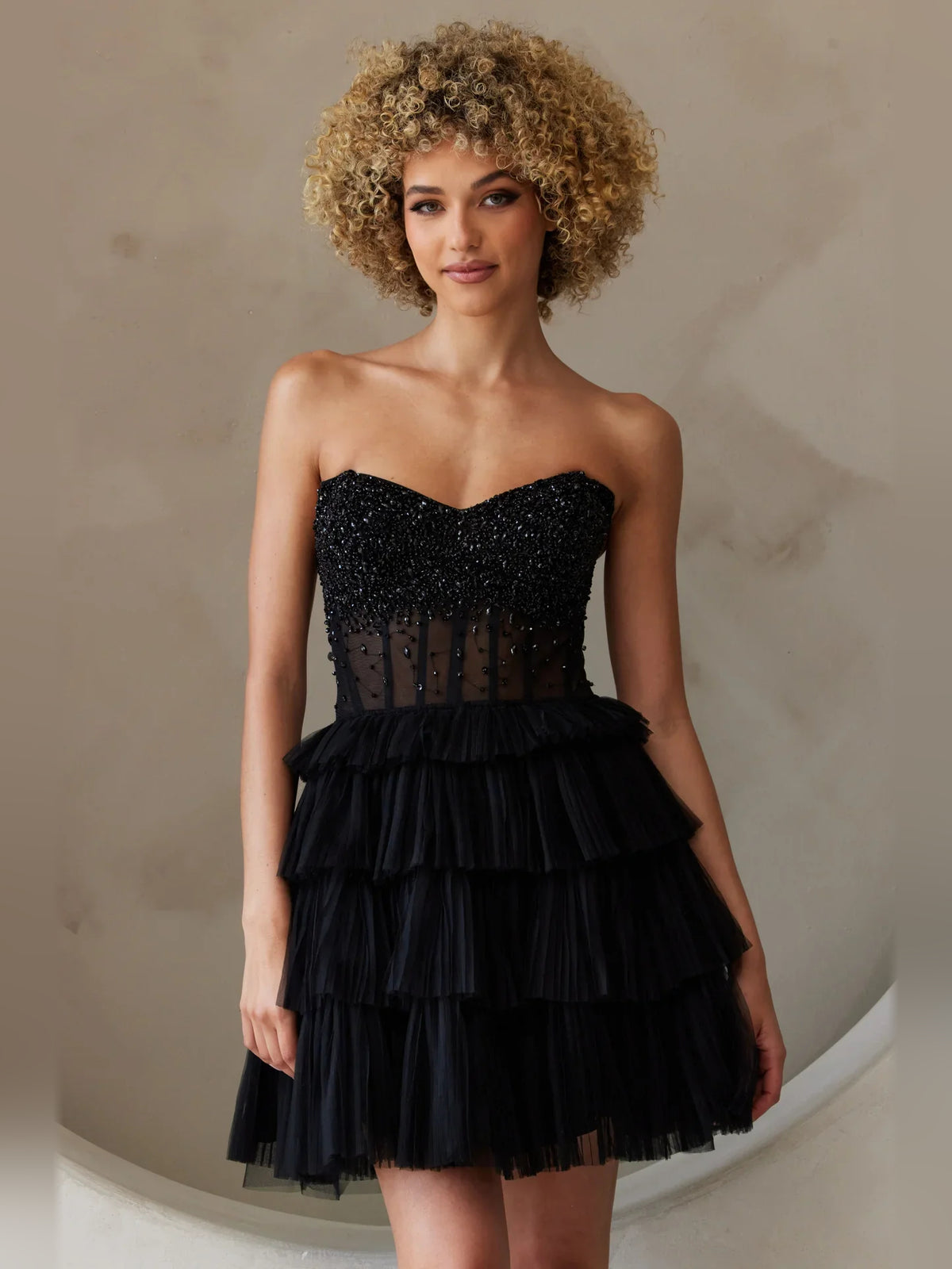 Black mini homecoming dress, alternate view showing the dress shape and hem