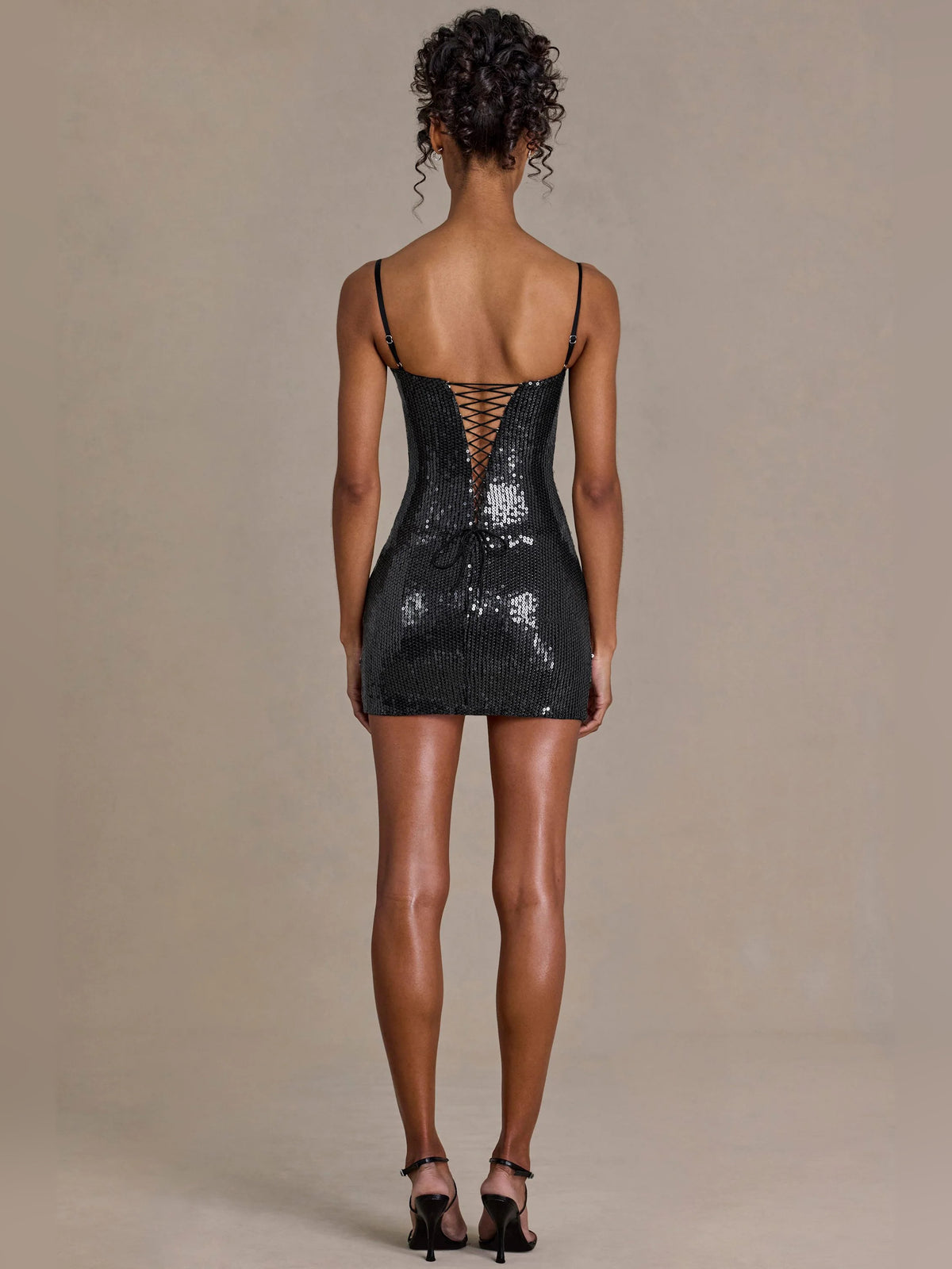 Black mini homecoming dress, alternate view showing the dress shape and hem