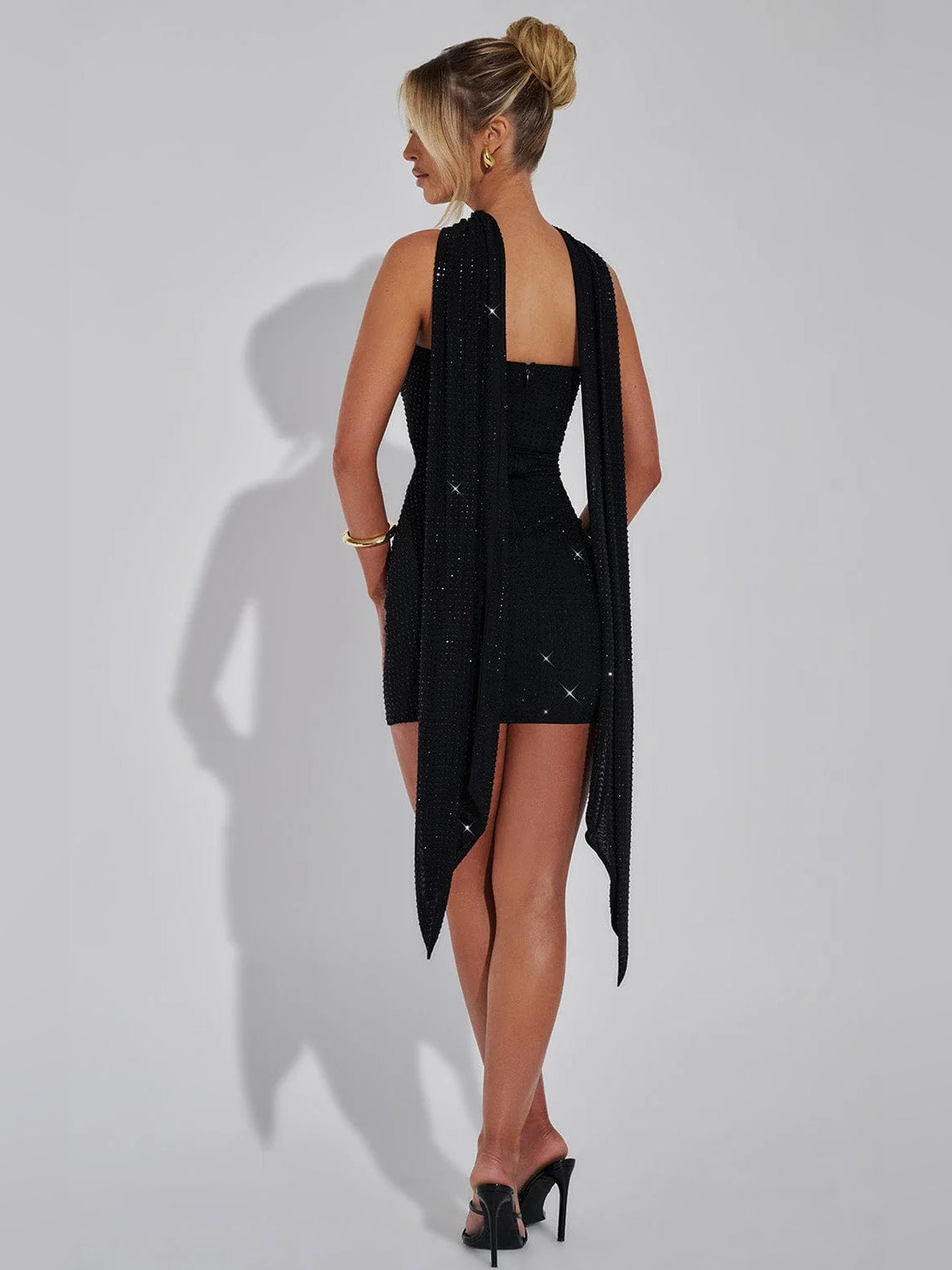 Black mini homecoming dress, alternate view showing the dress shape and hem