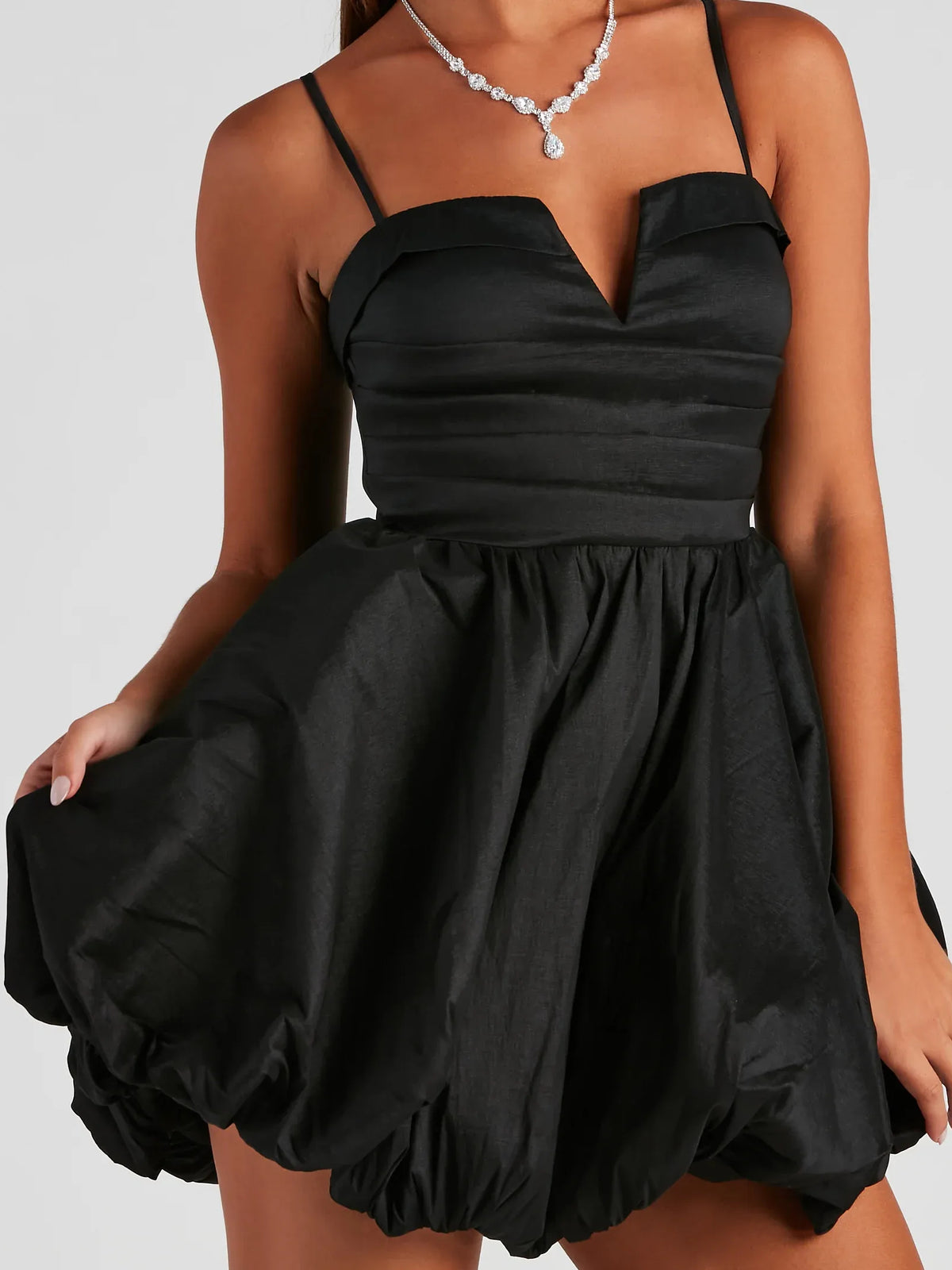 Black mini homecoming dress, alternate view showing the dress shape and hem
