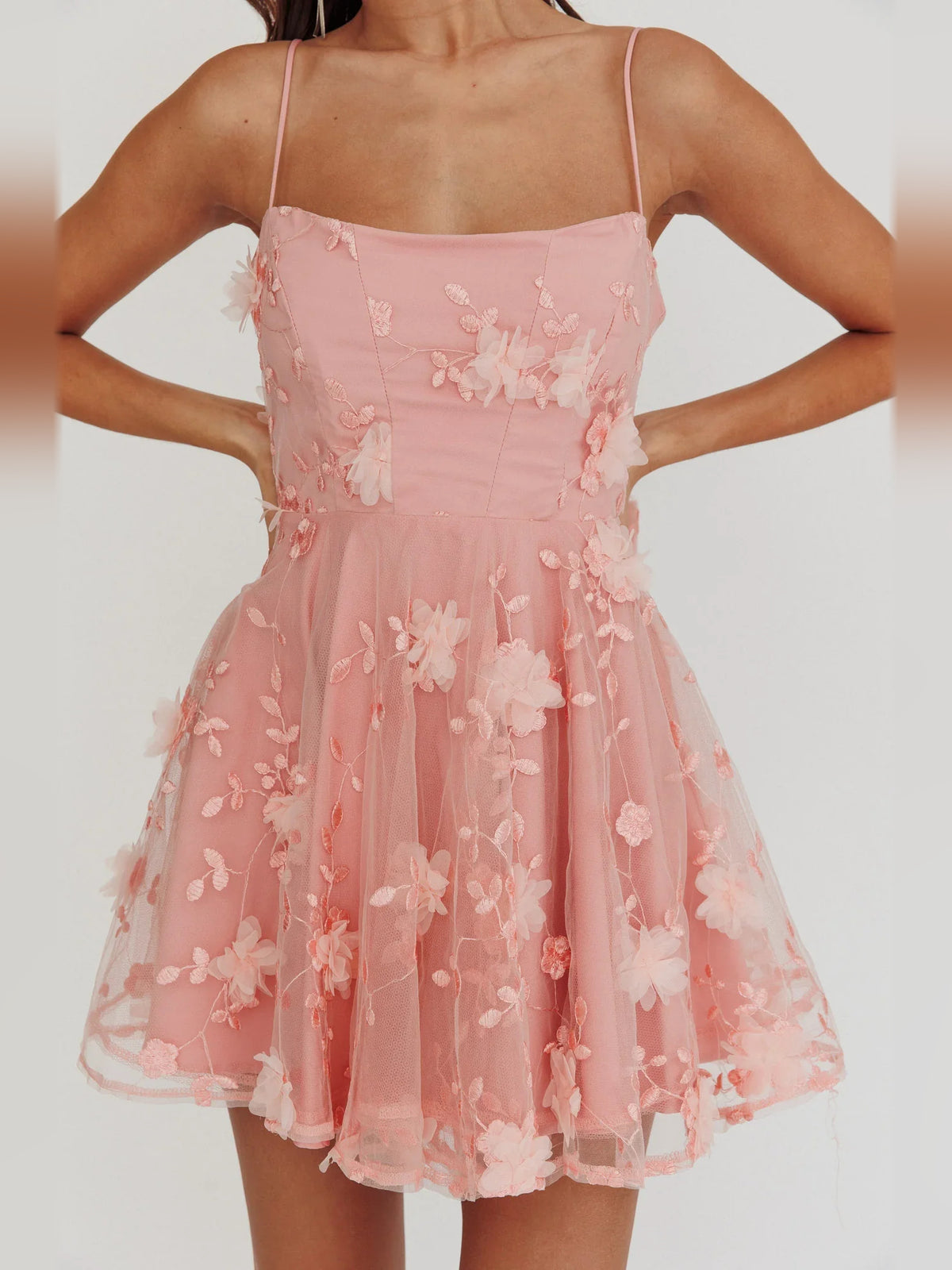 Coral mini homecoming dress, alternate view showing the dress shape and hem
