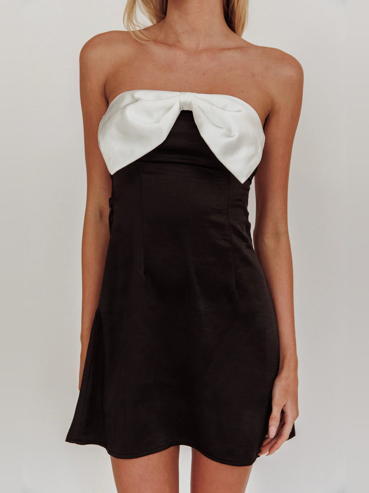 Black mini homecoming dress, alternate view showing the dress shape and hem