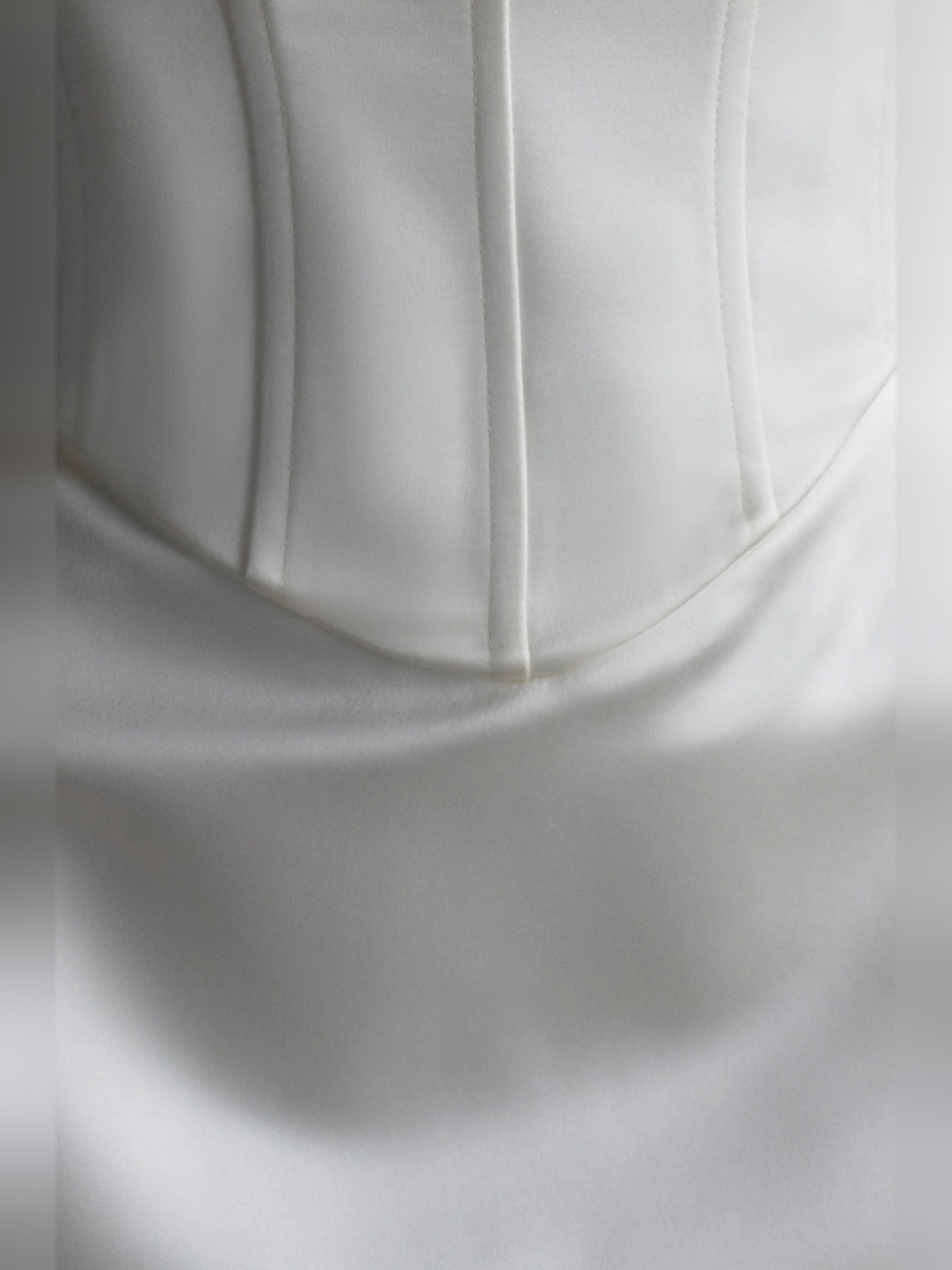 White mini homecoming dress, alternate view showing the dress shape and hem