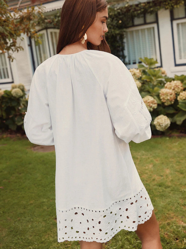 White mini homecoming dress, alternate view showing the dress shape and hem