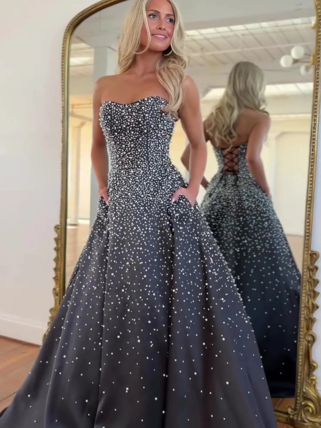 Black maxi prom dress, alternate view showing the skirt and hem