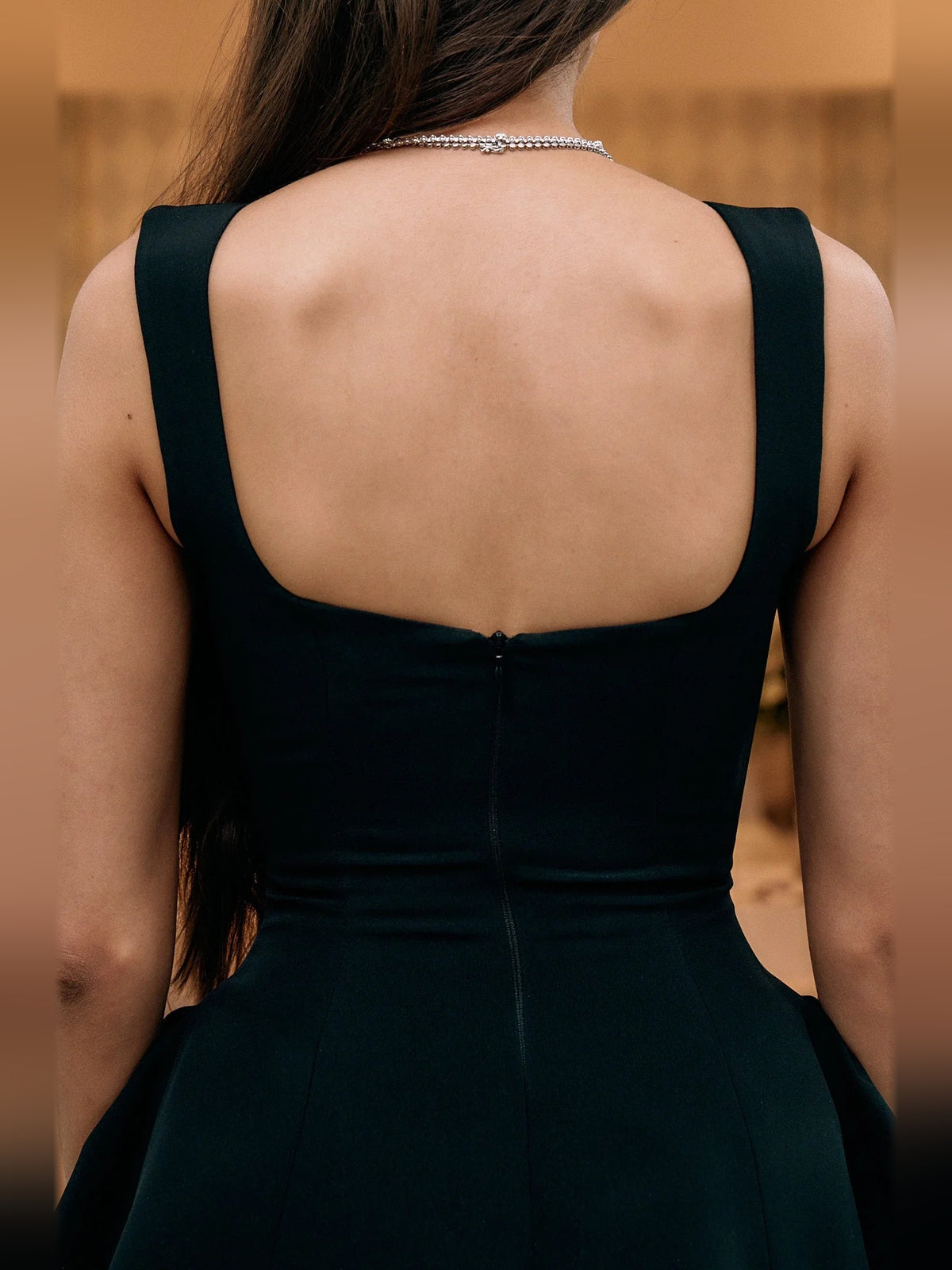 Black mini homecoming dress, alternate view showing the skirt and hem