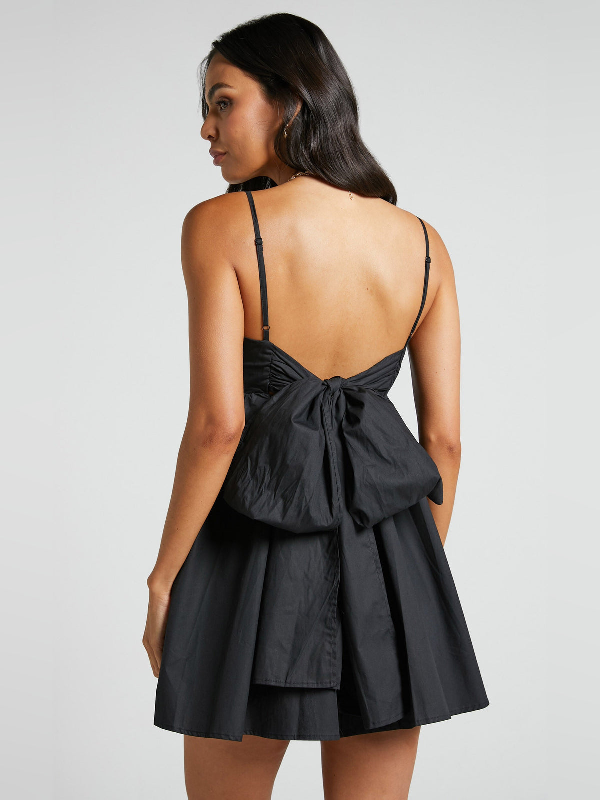 Black mini homecoming dress, alternate view showing the skirt and hem