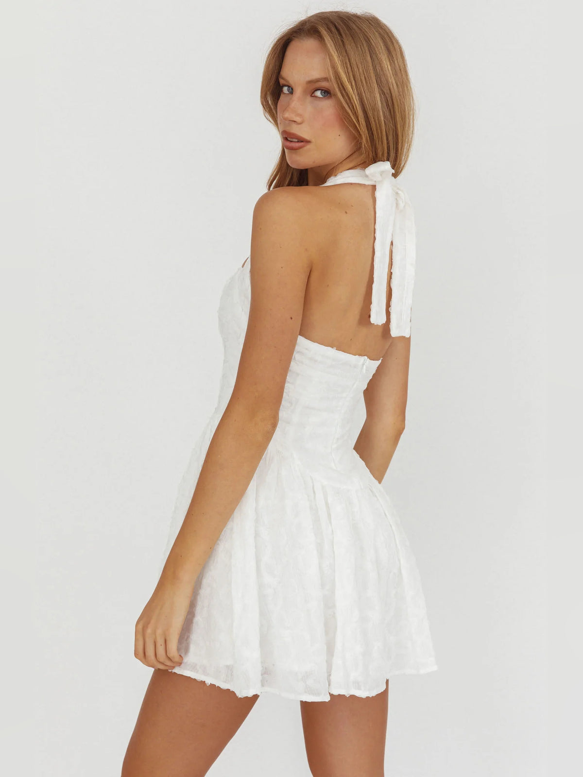 White mini homecoming dress, alternate view showing the skirt and hem
