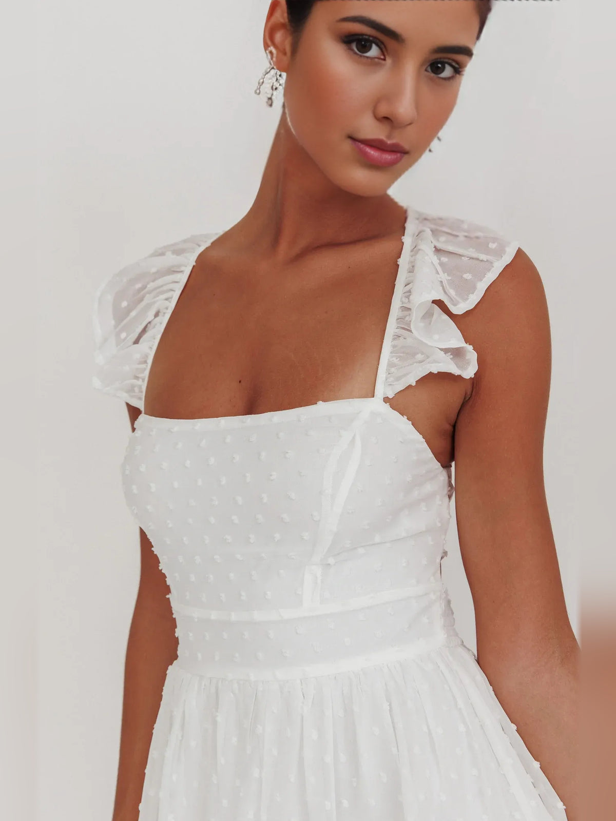 White mini homecoming dress, alternate view showing the skirt and hem