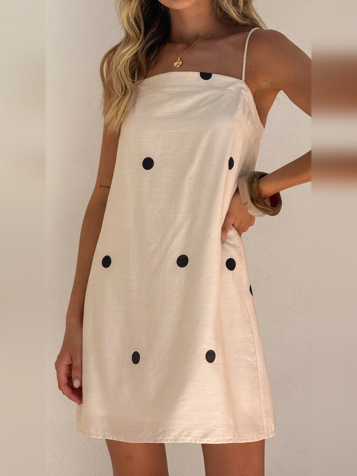 Cream mini homecoming dress, alternate view showing the skirt and hem