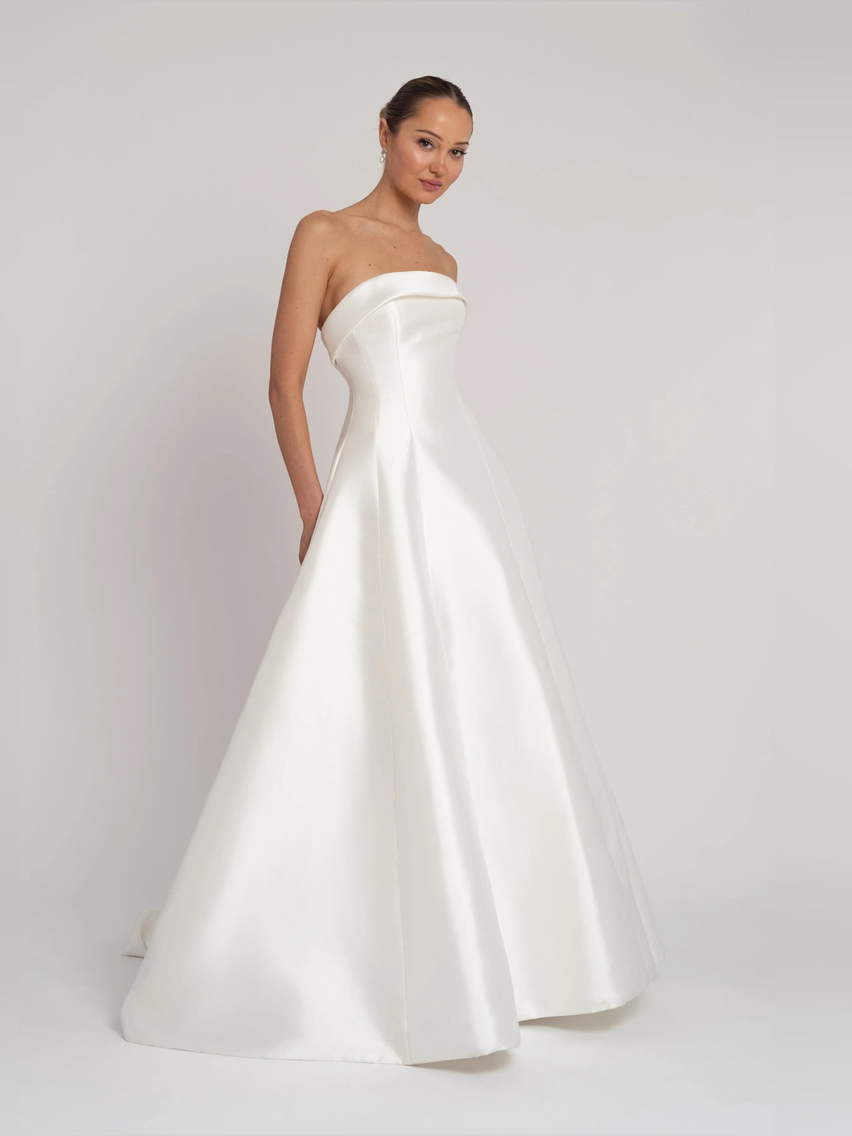 Ivory floor-length wedding dress, alternate view showing the skirt and hem