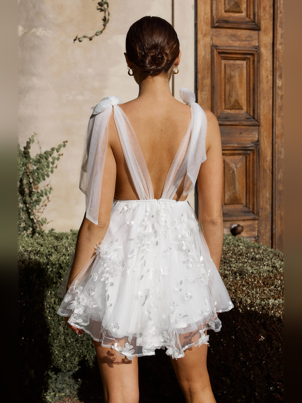 White mini homecoming dress, alternate view showing the skirt and hem