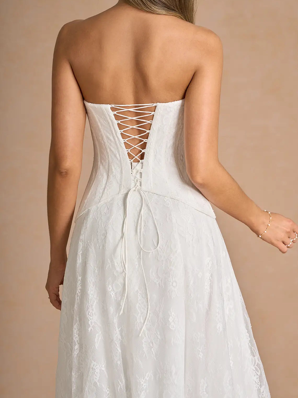 White column floor-length formal dress with corset-style bodice, alternate view showing the hem