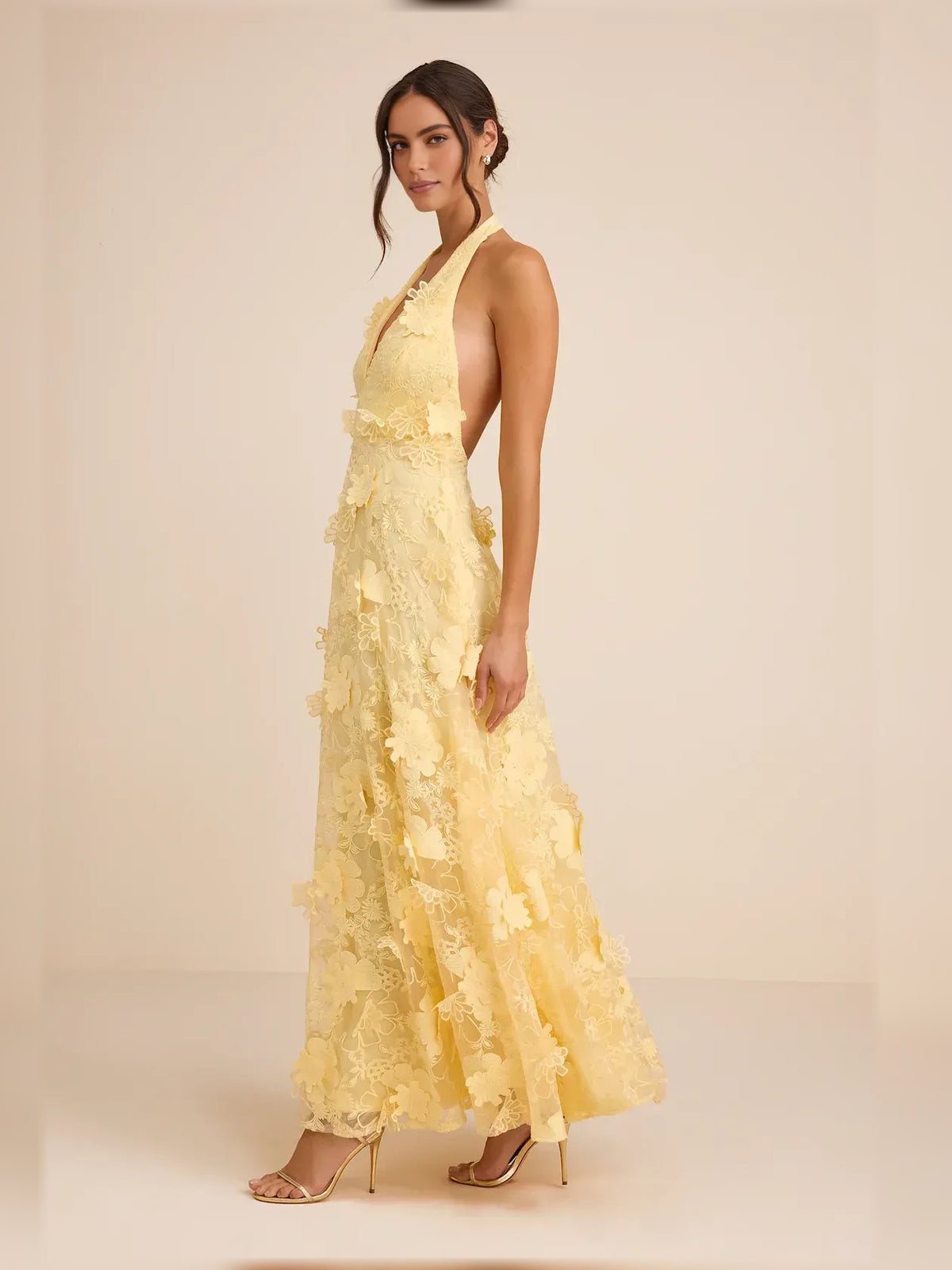 Black a-line maxi formal dress with floral appliqué, alternate view showing the hem