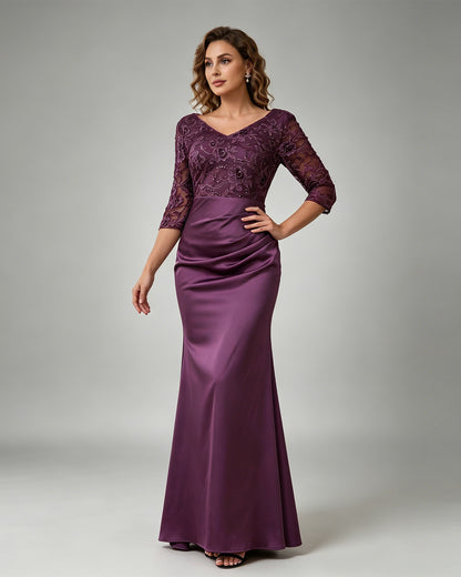 floor length mother of the bride dress with floral lace bodice, V neckline, sheer three-quarter sleeves, and mermaid skirt